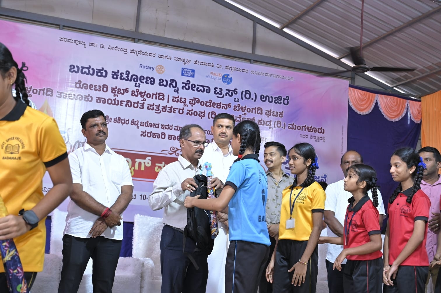Distribution of Bags and umbrellas to High school students