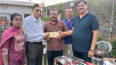 Handing over a cheque of Rs.9000/- Adult Literacy